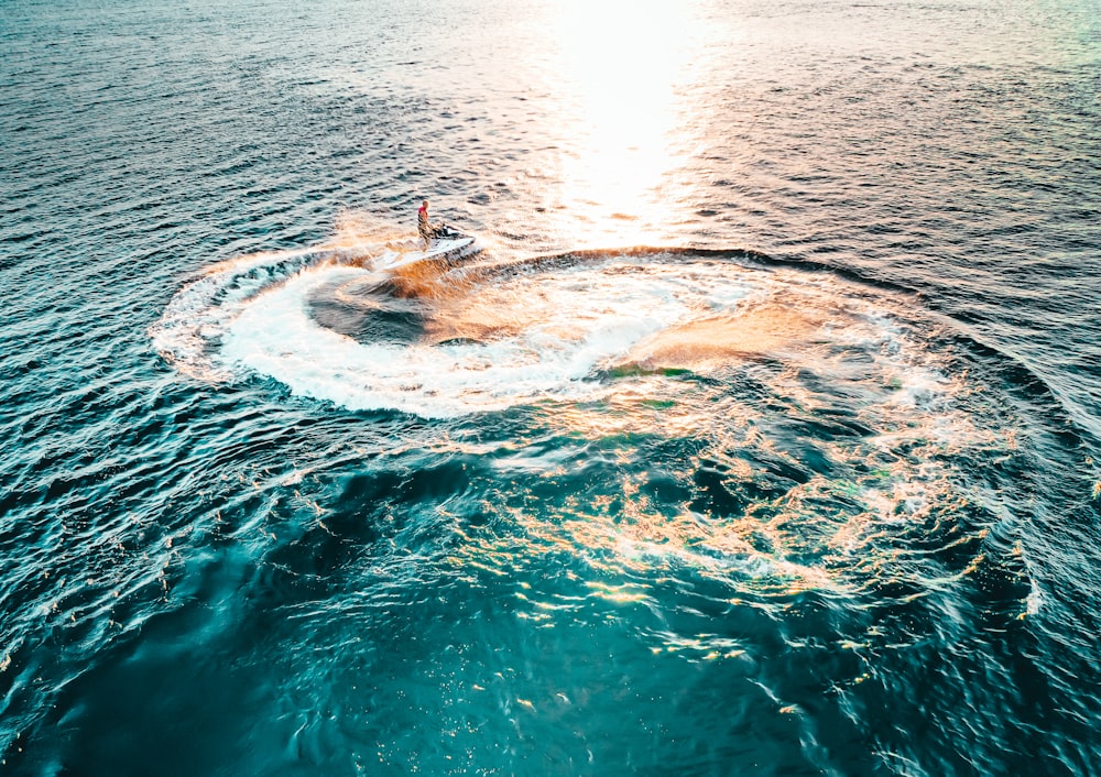 person surfing on sea waves during daytime