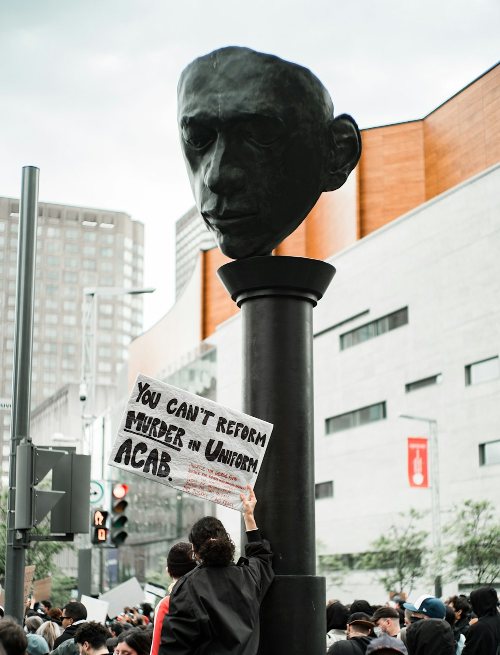 man in black jacket standing near black statue