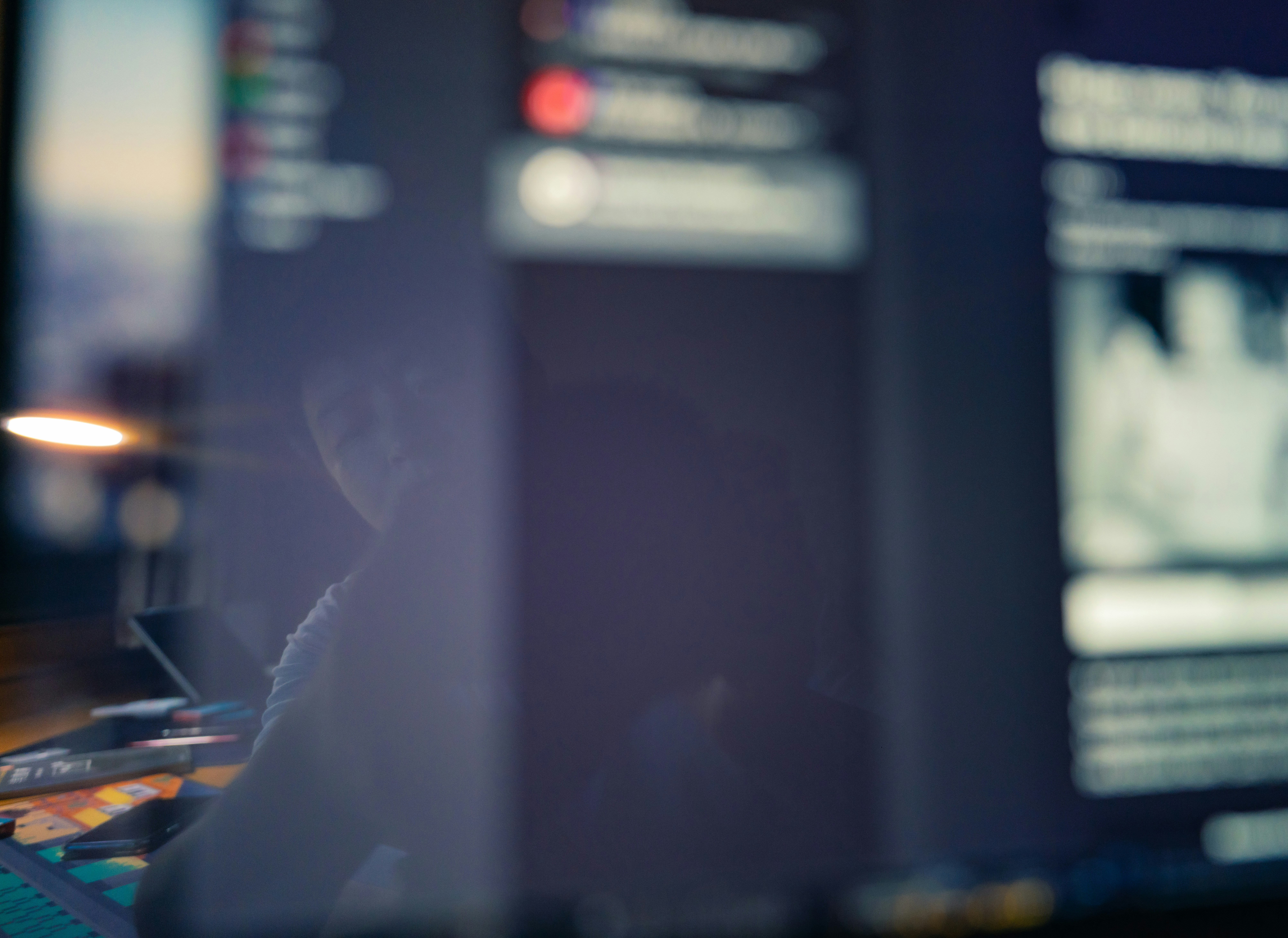 A content creator carefully reviews text on a computer screen, symbolizing the crucial human verification of AI-generated content for accuracy.