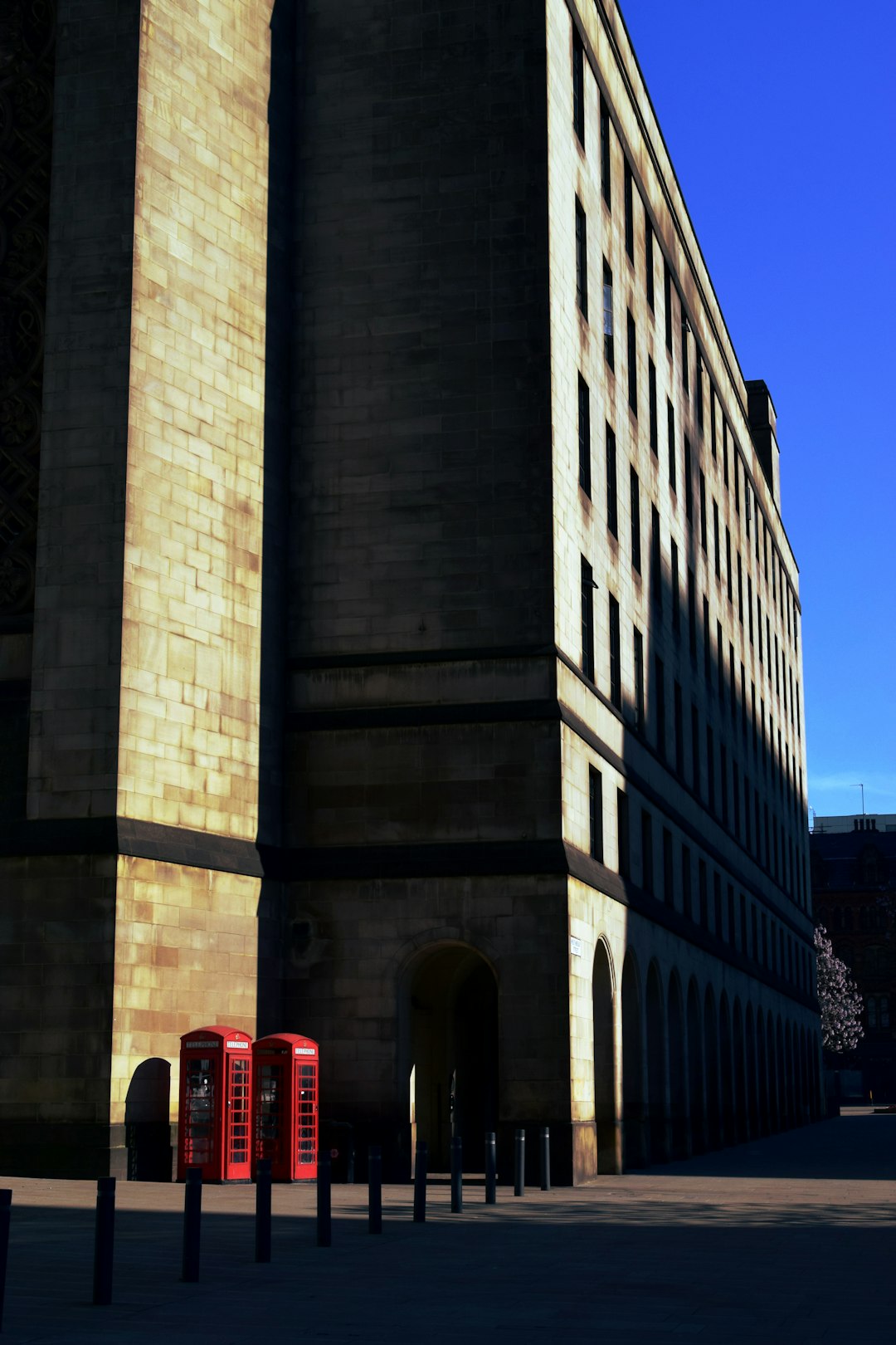 red bus in front of brown concrete building during daytime