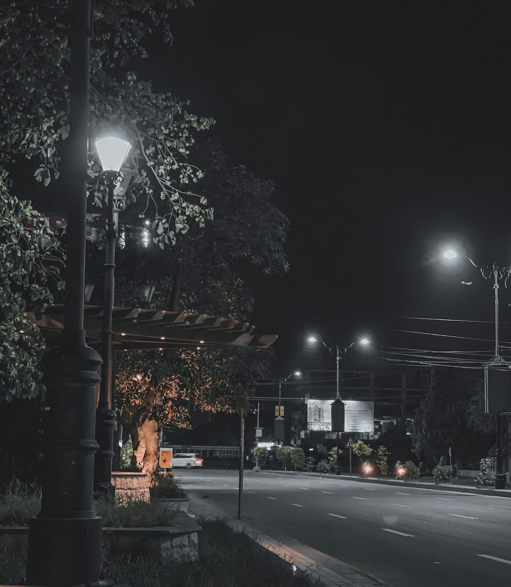 lighted street lamp near road during night time