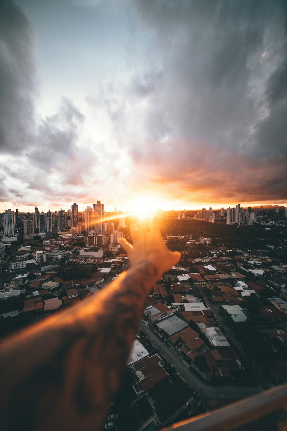 city with high rise buildings under white clouds during daytime