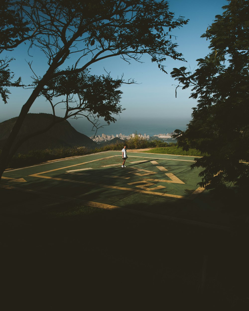 person walking on sand near body of water during daytime