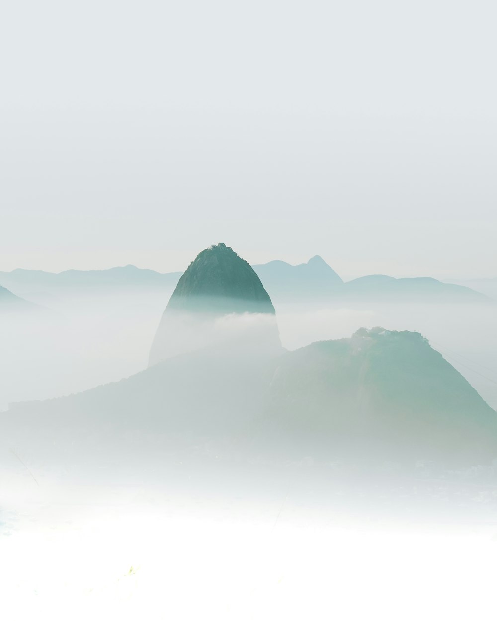 black mountains covered with white fog