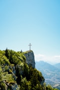 cross on top of mountain during daytime