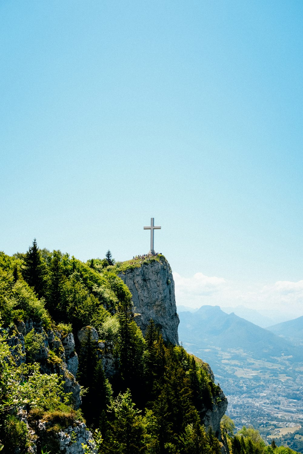 cross on top of mountain during daytime