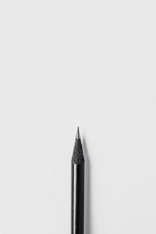black pencil on white surface