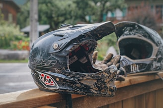 A close-up of a motorcycle helmet and gloves on a table.