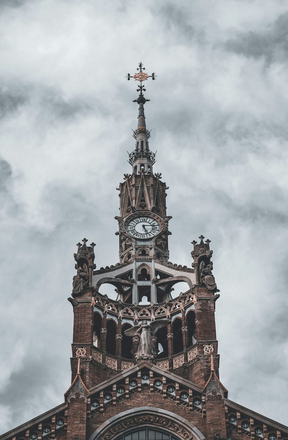 brown and black concrete building under white clouds during daytime