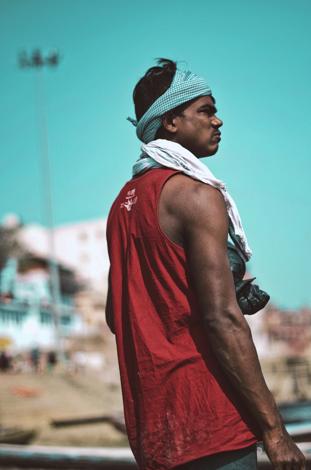 man in red tank top wearing white and blue scarf