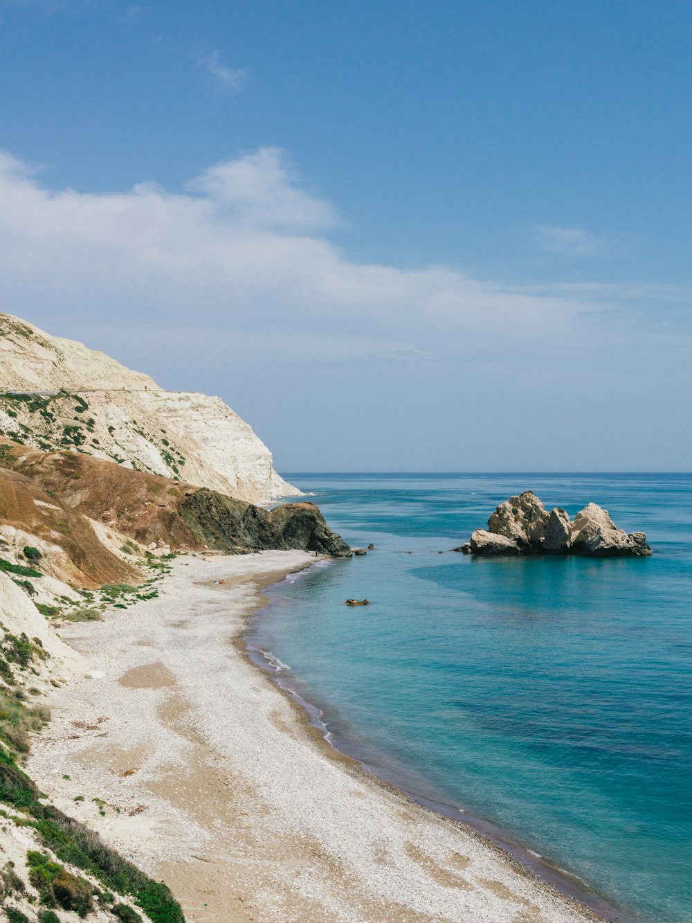 brown rock formation on blue sea under blue sky during daytime