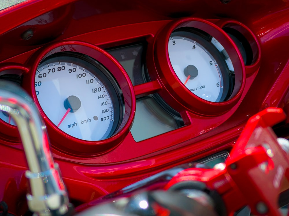 red and silver round gauge