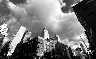 A striking cityscape showing a mix of old and new architecture under a dramatic sky.