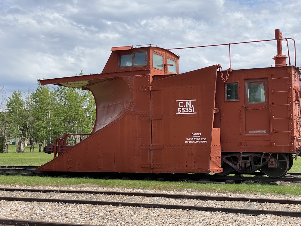 brown train on rail tracks during daytime