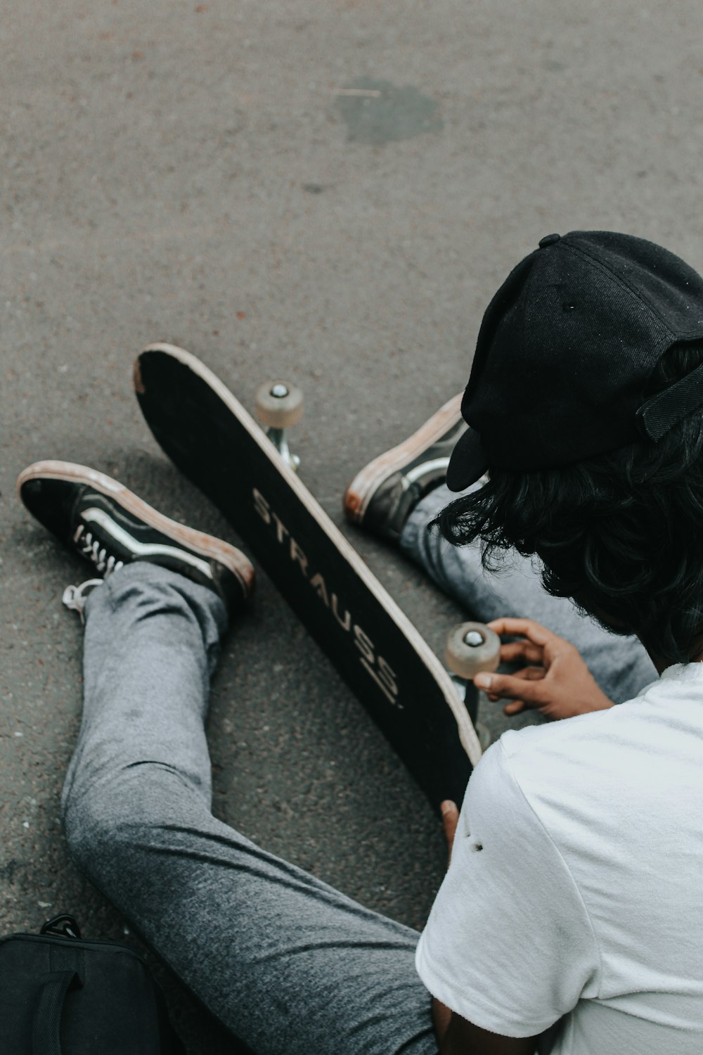 person in black and white nike sneakers holding black skateboard photo –  Free Grey Image on Unsplash