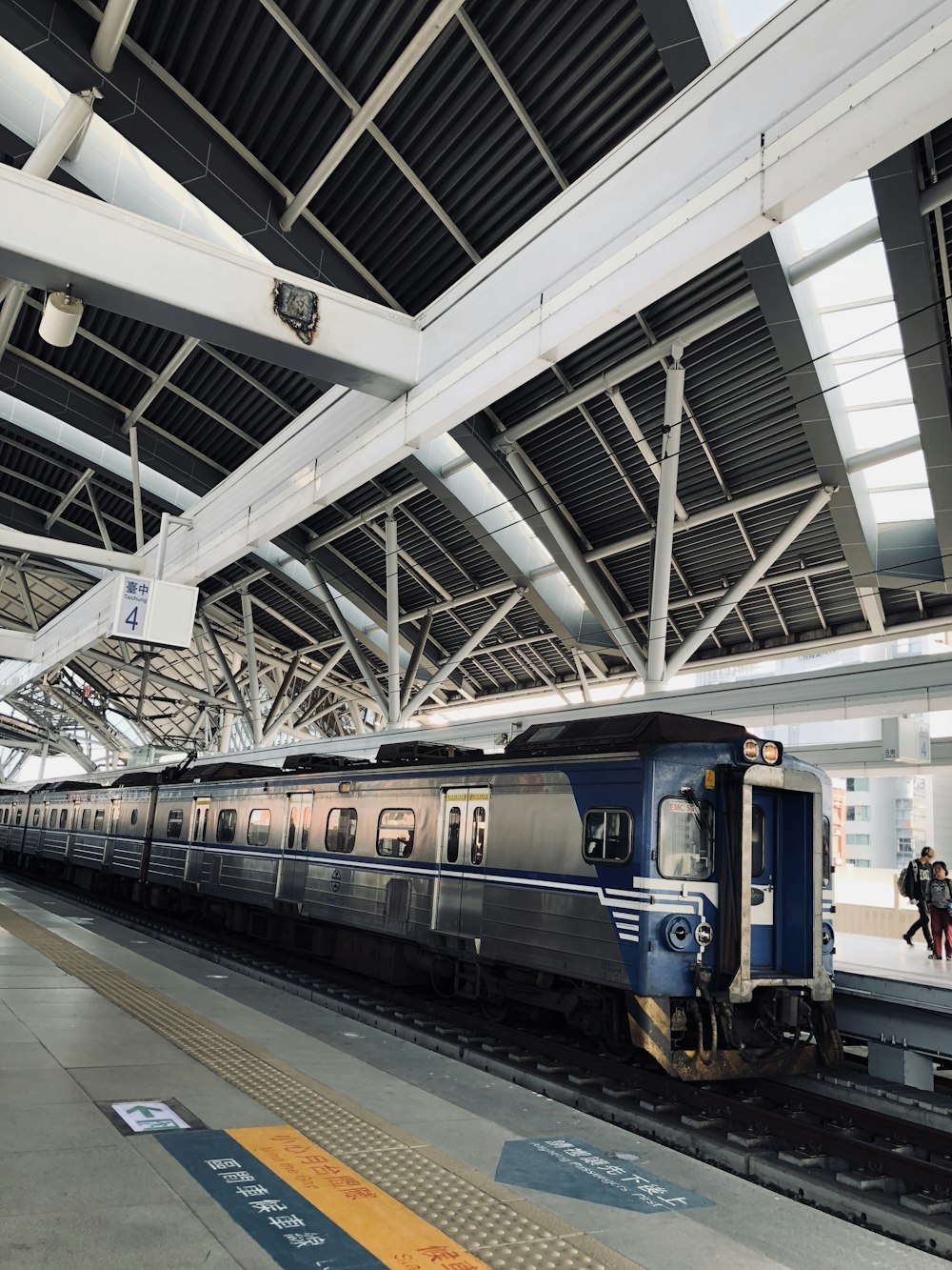 blue and black train in train station