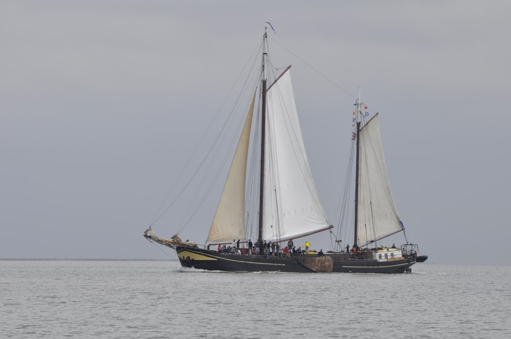 brown and white sail boat on sea during daytime