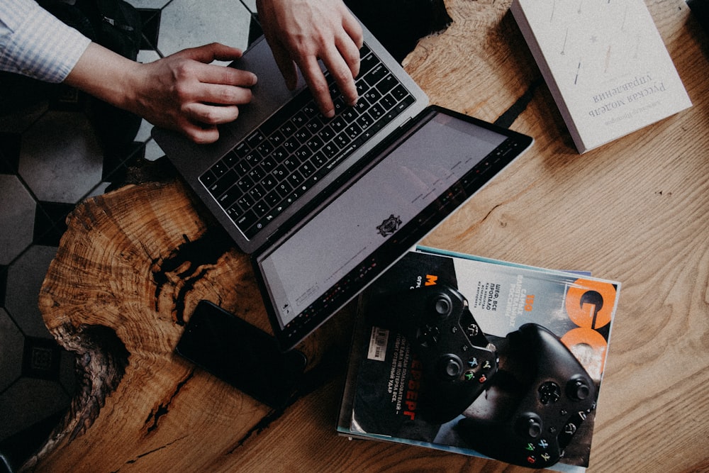 person using black and silver laptop computer