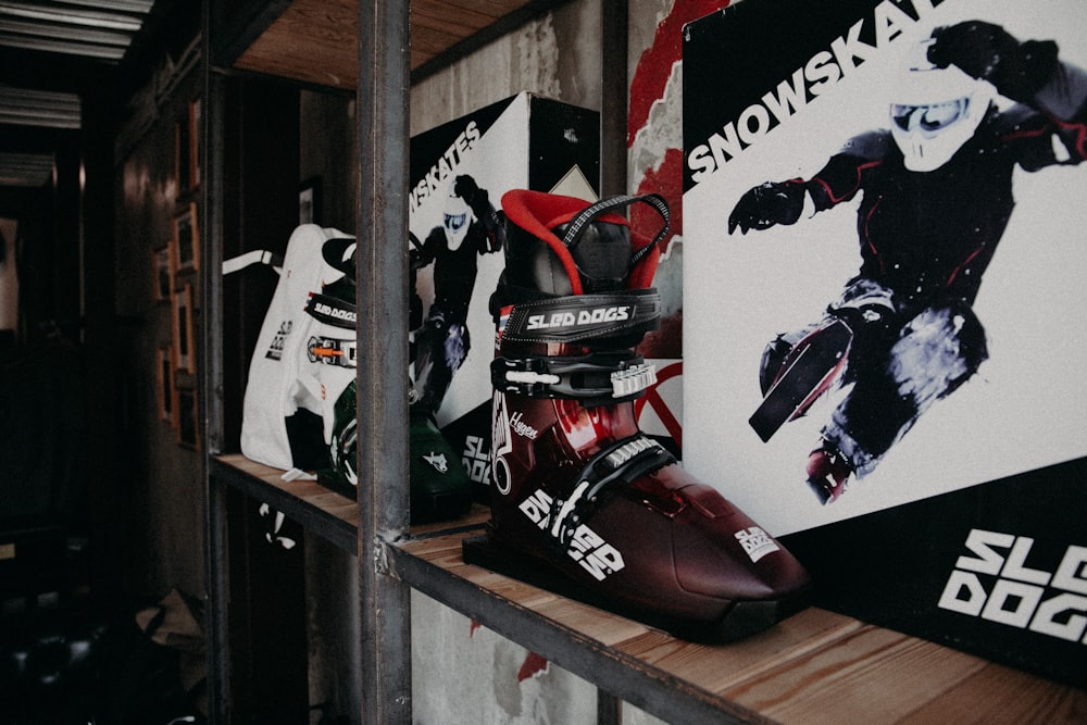red and black motorcycle on brown wooden shelf