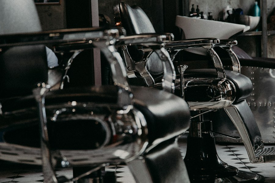 Black leather and chrome barber chairs on a checkered floor