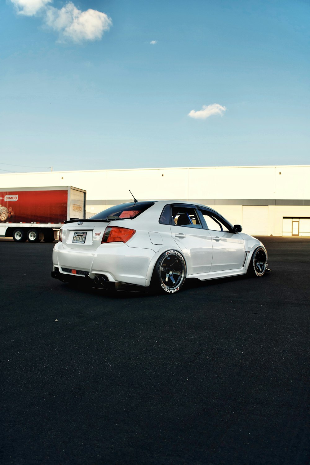 white coupe parked on parking lot during daytime