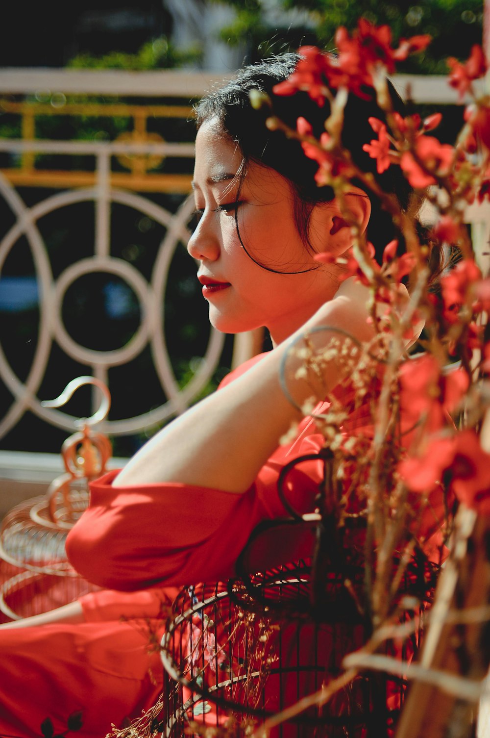 woman in red dress sitting on red and white chair