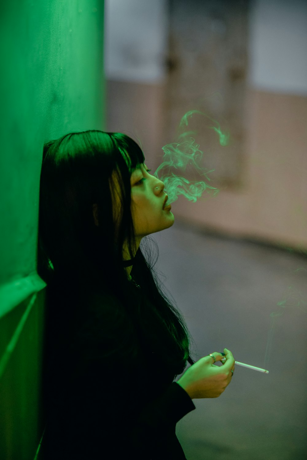 woman in black jacket smoking cigarette