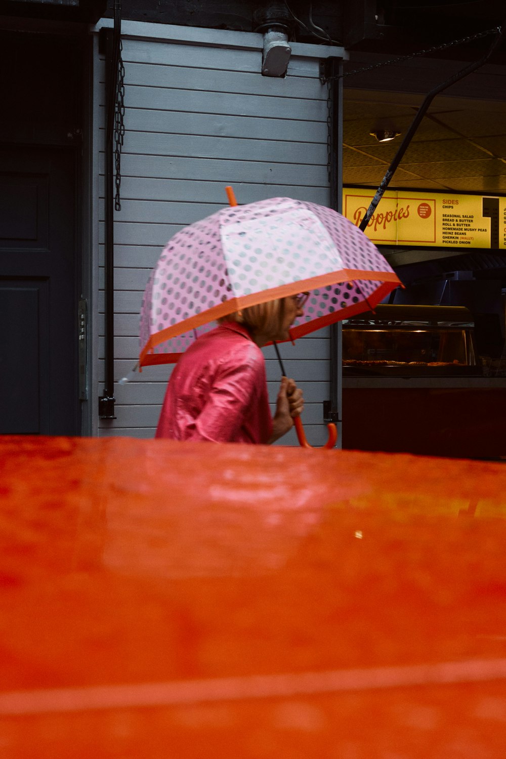 girl in red jacket holding umbrella