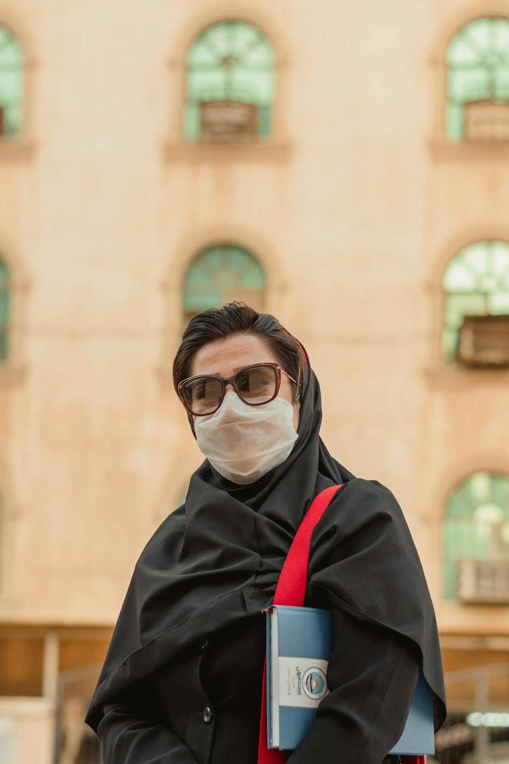 woman in black coat wearing black framed eyeglasses