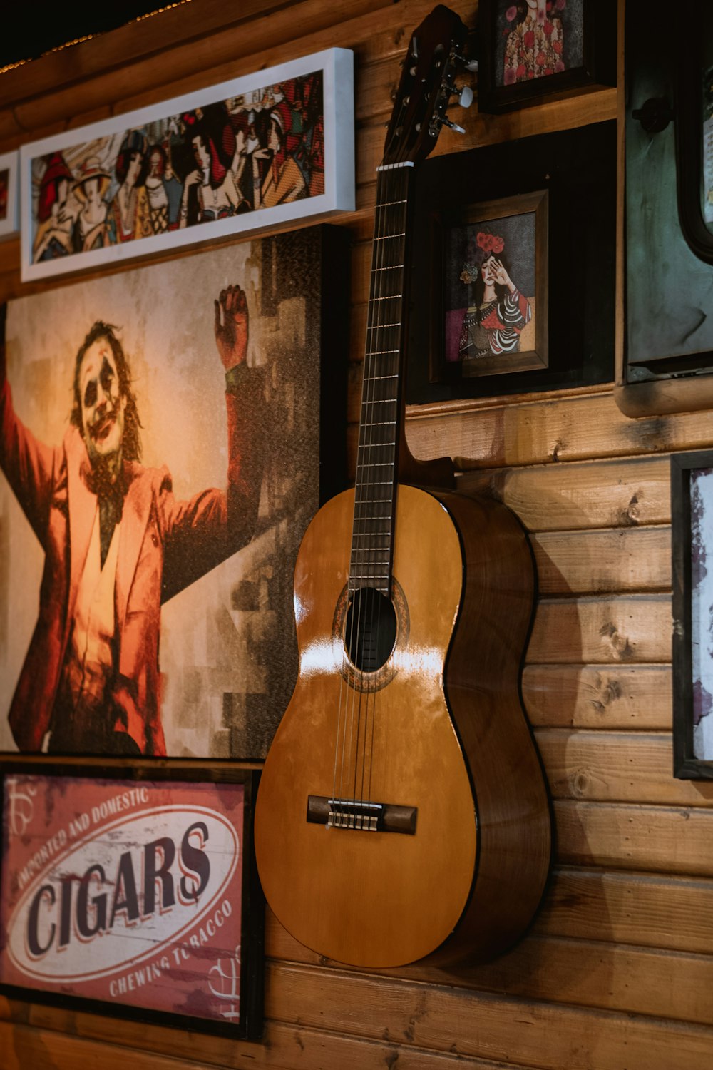 brown acoustic guitar on wall