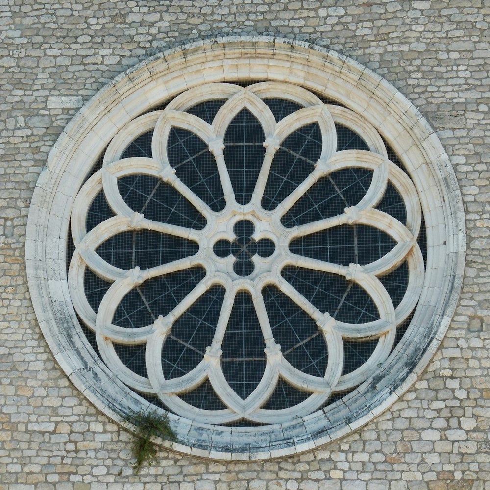 gray metal wheel on brown brick wall