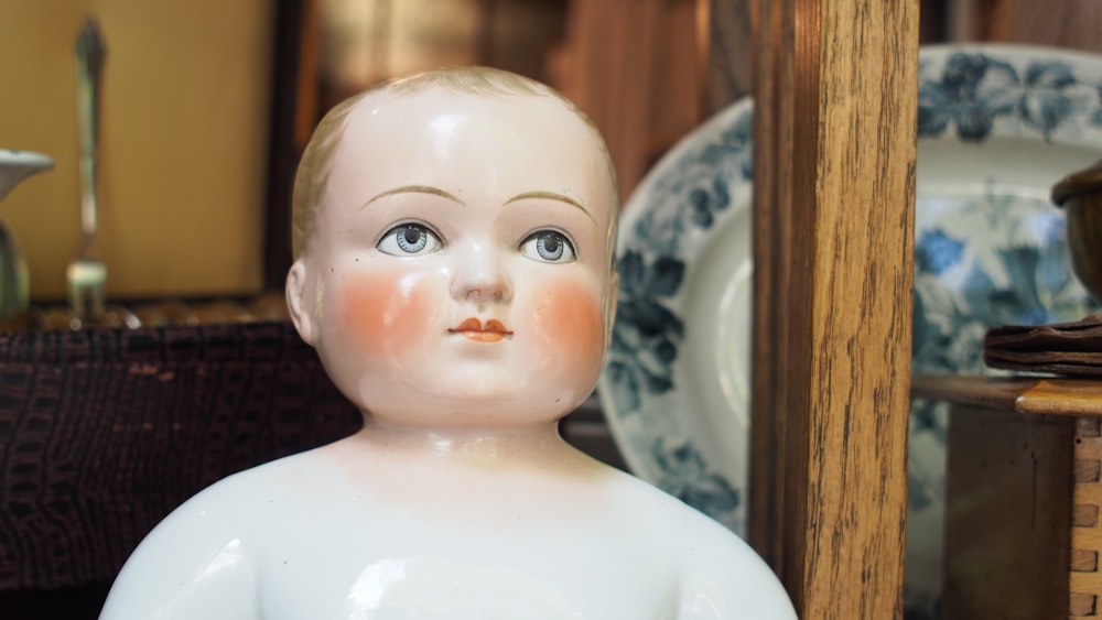 baby ceramic figurine on white ceramic plate