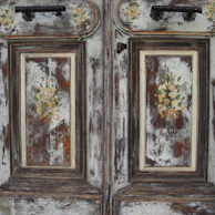 Restored vintage wooden door with fresh paint and elegant details.