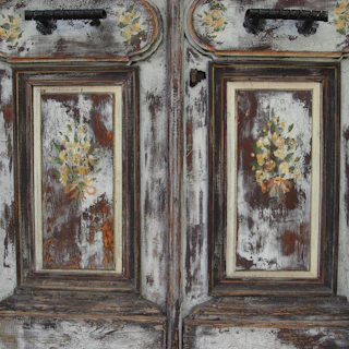 Restored vintage wooden door with fresh paint and elegant details.