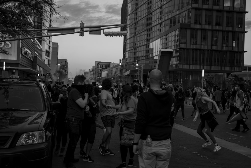 grayscale photo of people walking on street