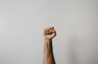 persons right foot on white wall
