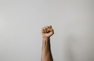 persons right foot on white wall