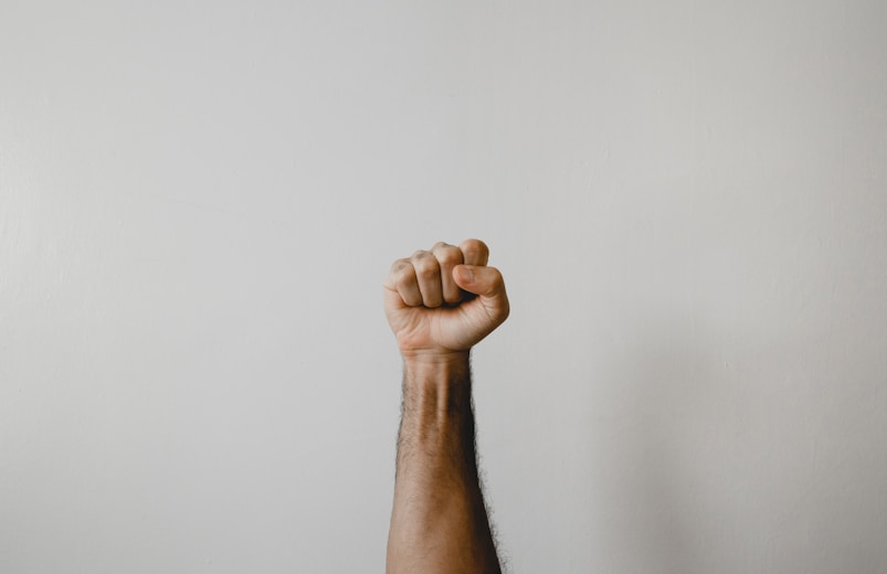 persons right foot on white wall