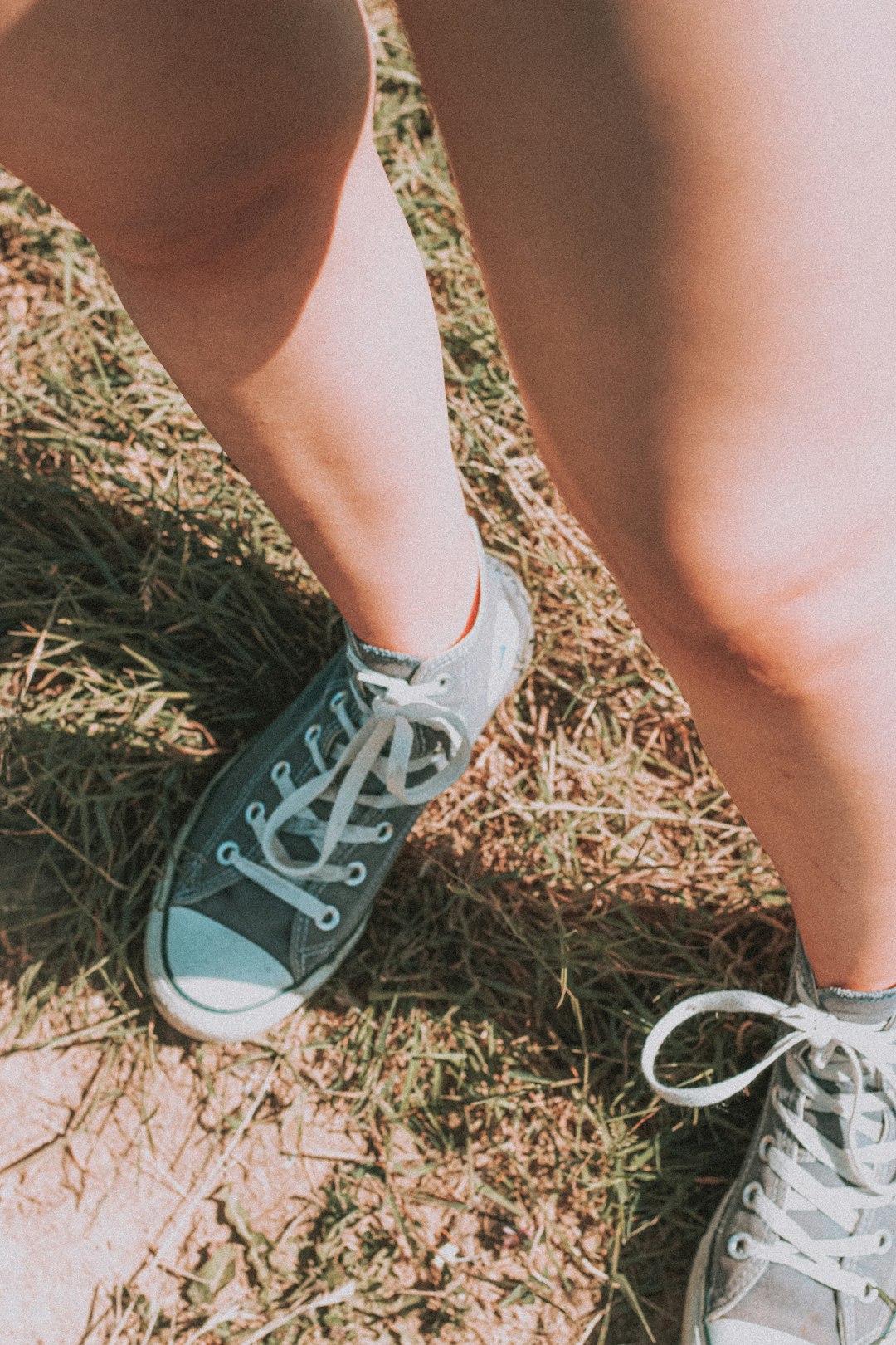 person wearing gray and white converse all star low top sneakers