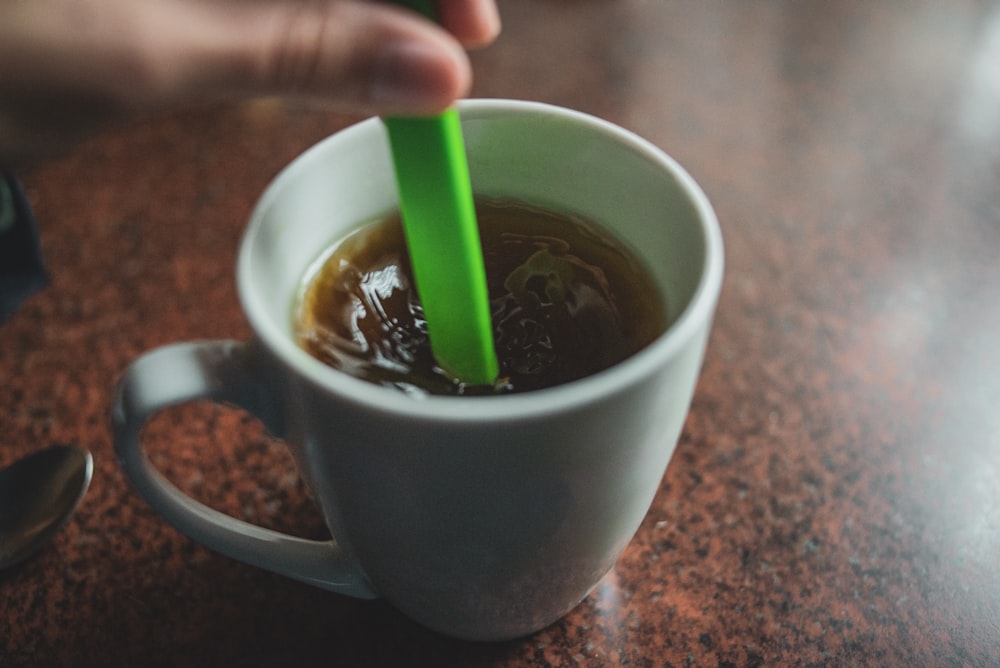 white ceramic mug with green liquid