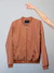 brown long sleeve shirt on white clothes hanger