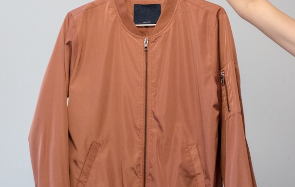 brown long sleeve shirt on white clothes hanger