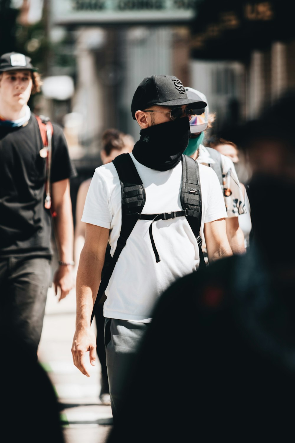 man in white and black backpack