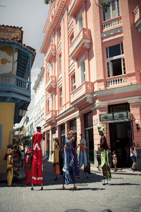 people walking on street near brown concrete building during daytime in Hotel Ambos Mundos Cuba