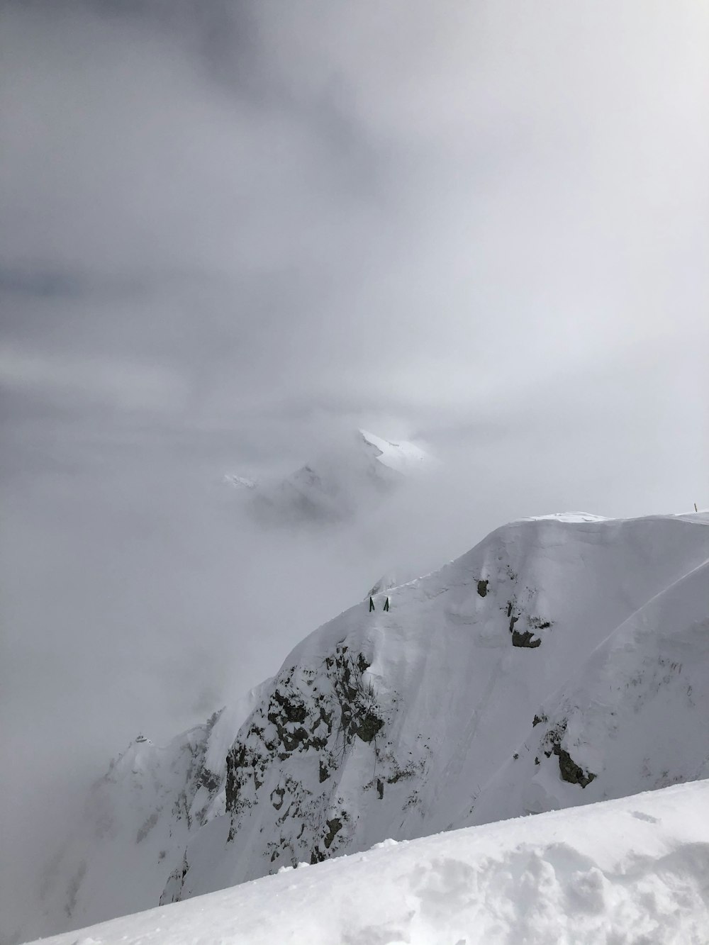 snow covered mountain under cloudy sky