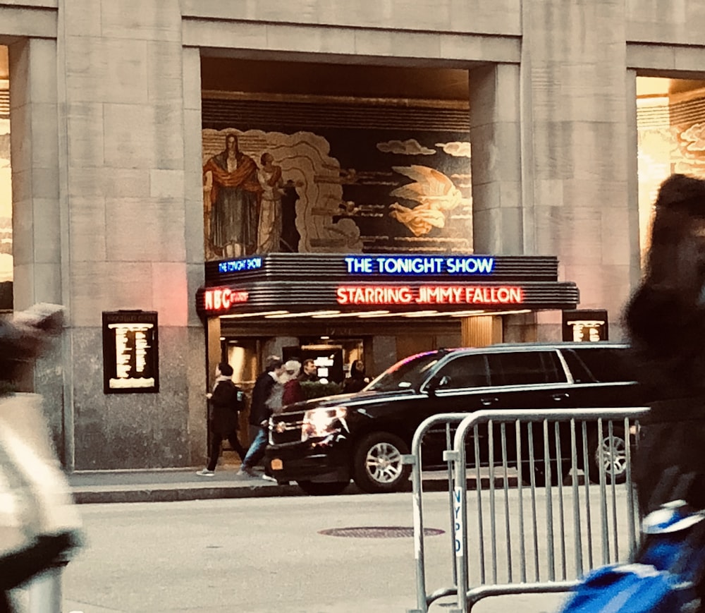 cars parked in front of building during daytime