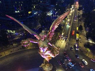 A serene guardian angel gently watching over a bustling city street below.