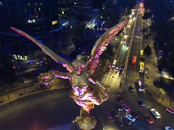 A serene guardian angel gently watching over a bustling city street below.