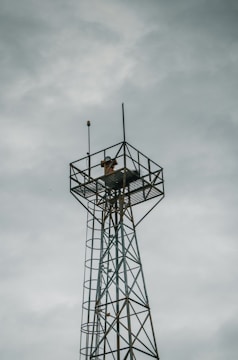 gray metal tower under gray sky