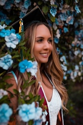 A graduate in a cap and gown showcasing flawless makeup for her special day.